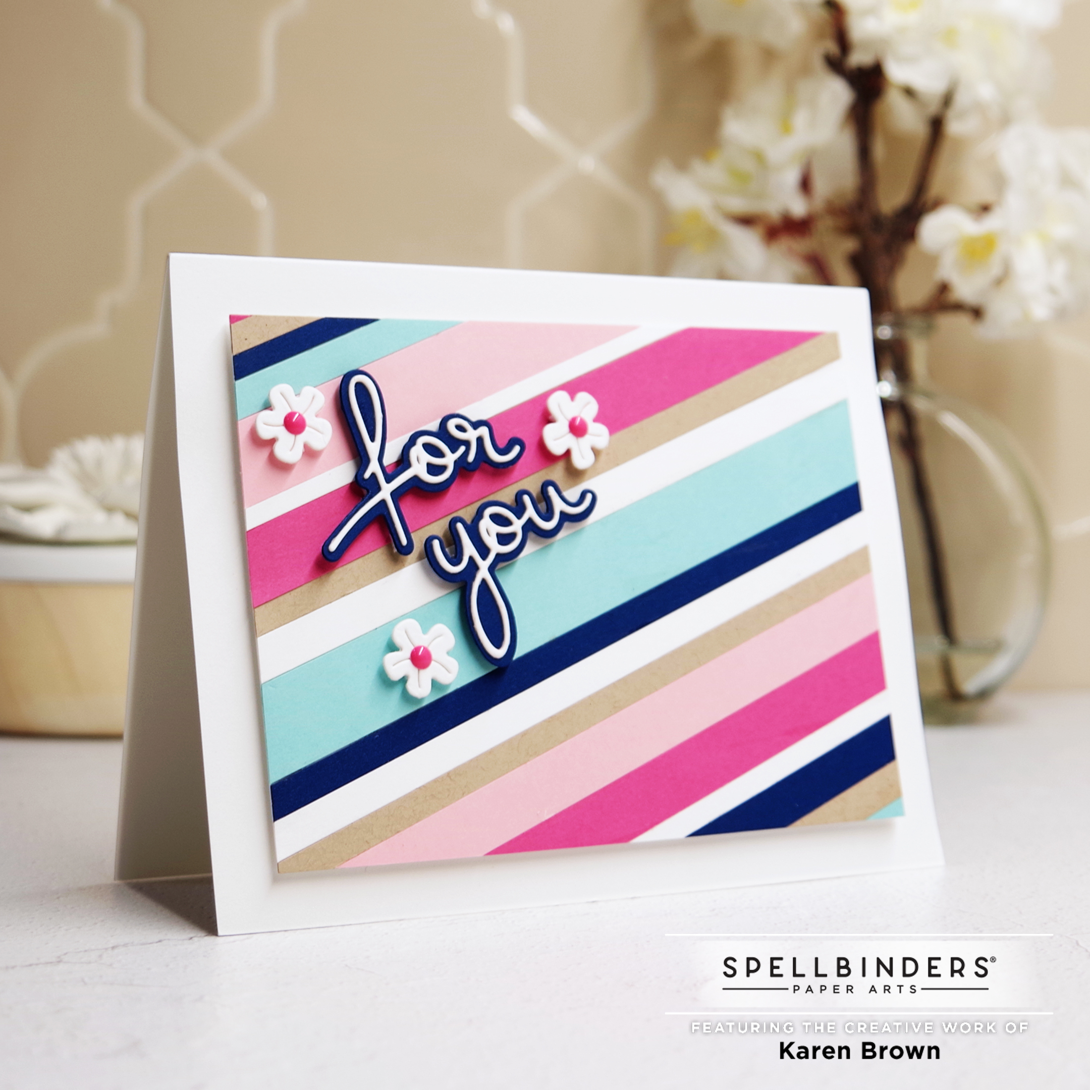 Handmade card with striped background in pink, white, aqua, blue and tan kraft paper cardstock. 