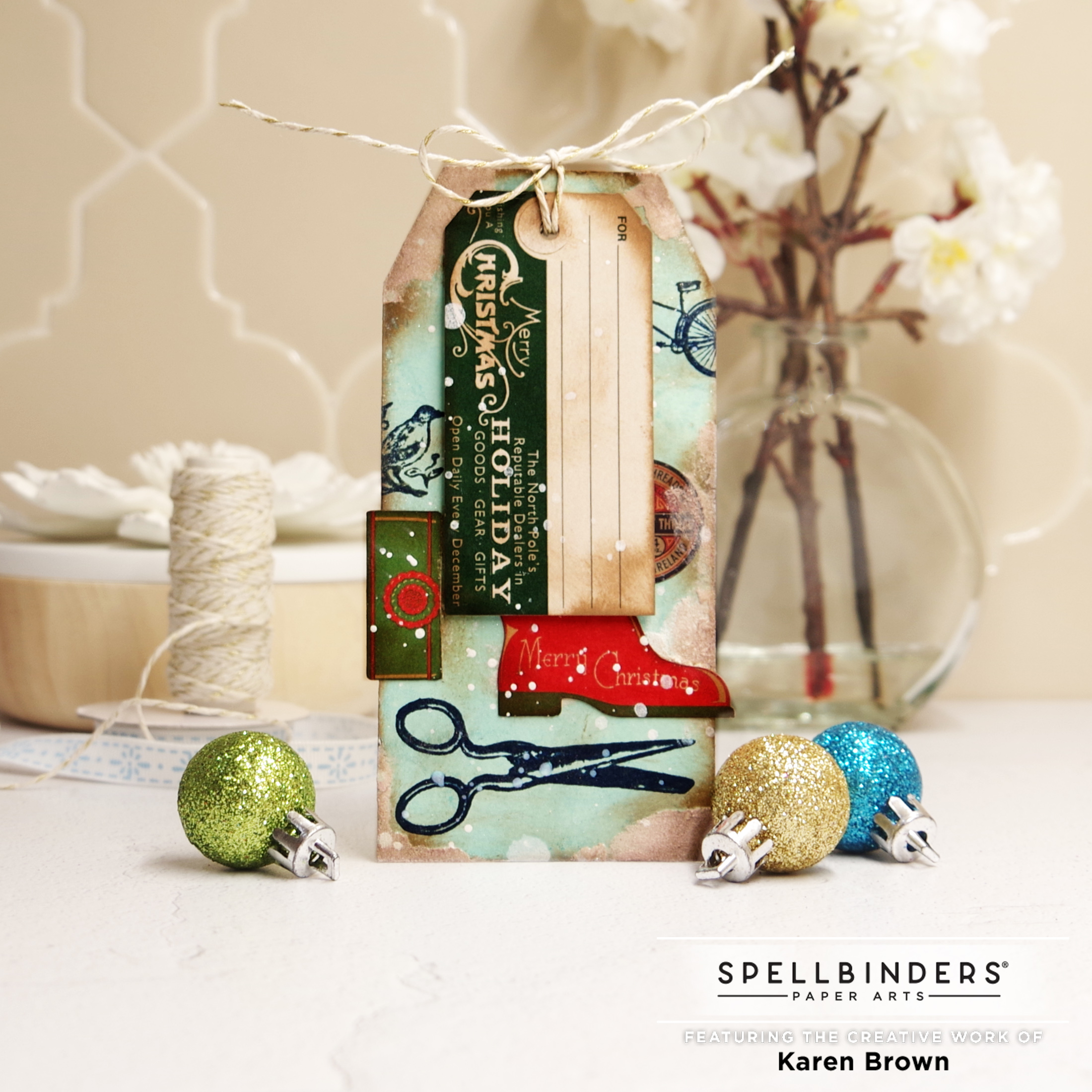 Distressed Christmas gift tag with pre-printed die cuts, stamp and stickers with a hand dyed aqua background.