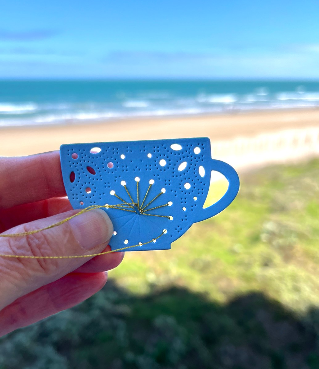 Papercrafting and stitching at the beach.