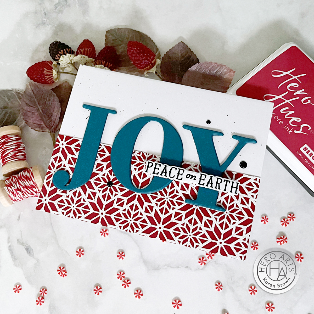 "JOY" die cut and heat embossed Christmas card with fine black heat spatter and Adriatic teal and Crimson red color scheme.