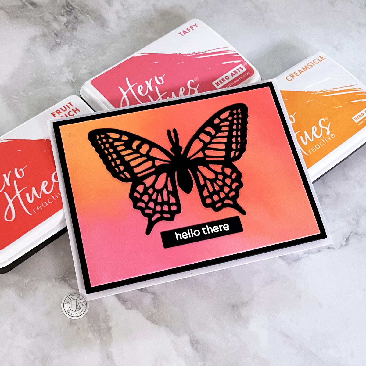 Bold pink, coral and orange ink blended background with a lovely die cut black butterfly focal element.  Hero Arts Delicate Butterfly Fancy Die.