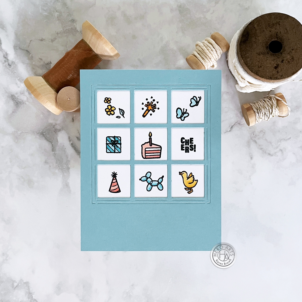 Charming 9 window pane stamped and die cut birthday card featuring small stamped images of cake, party hats, balloon animal, duck, butterflies and flowers. 