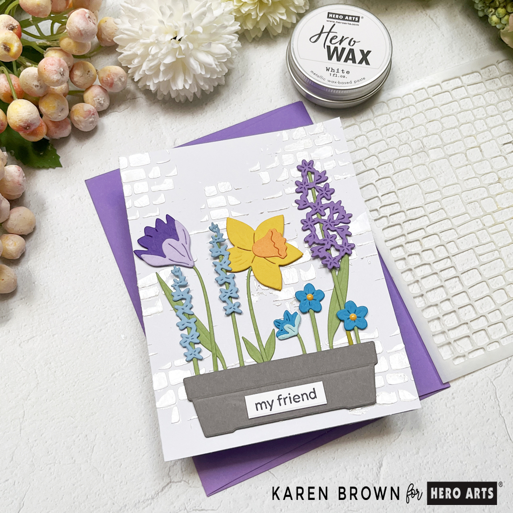 Using White Hero Wax to stencil a subtle pearlescent background for a Spring die cut floral card.