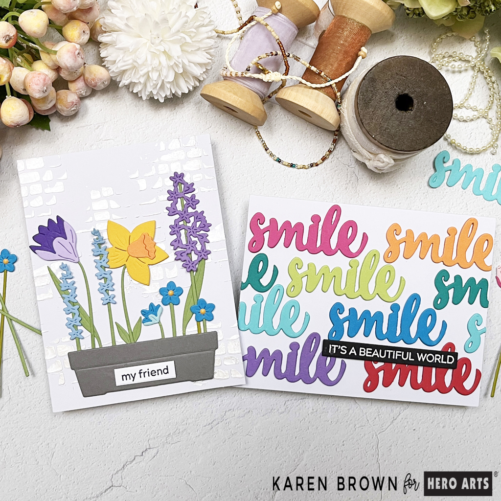 Two lovely spring die-cut cards in bright fun colors.  One is floral and other has repeating smile sentiment sin rainbow color order. 