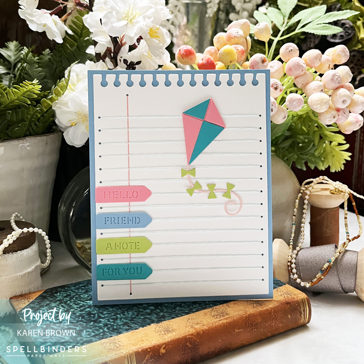 Spellbinders April 2025 Stitched Die of the Month Kit Card featuring a background that looks like notebook paper with die cut page pointer sentiments and a die cut kite.