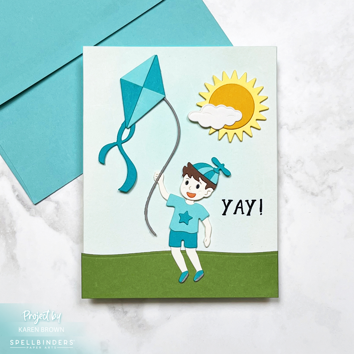 Die cut scene card with a boy flying a kite.  Spellbinders Up and Away die set - S4-1433.