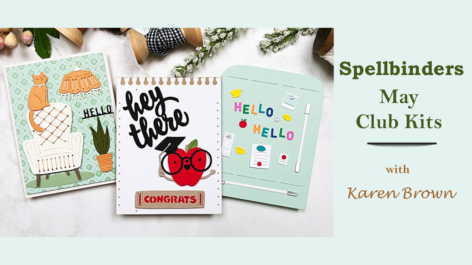 The Spellbinders May 2025 Club Kit Release is packed with charm:  a playful graduation card with a smiling apple, a cozy stitched living room scene with a cat, and a retro refrigerator card full of rainbow-hued fridge magnets. 
