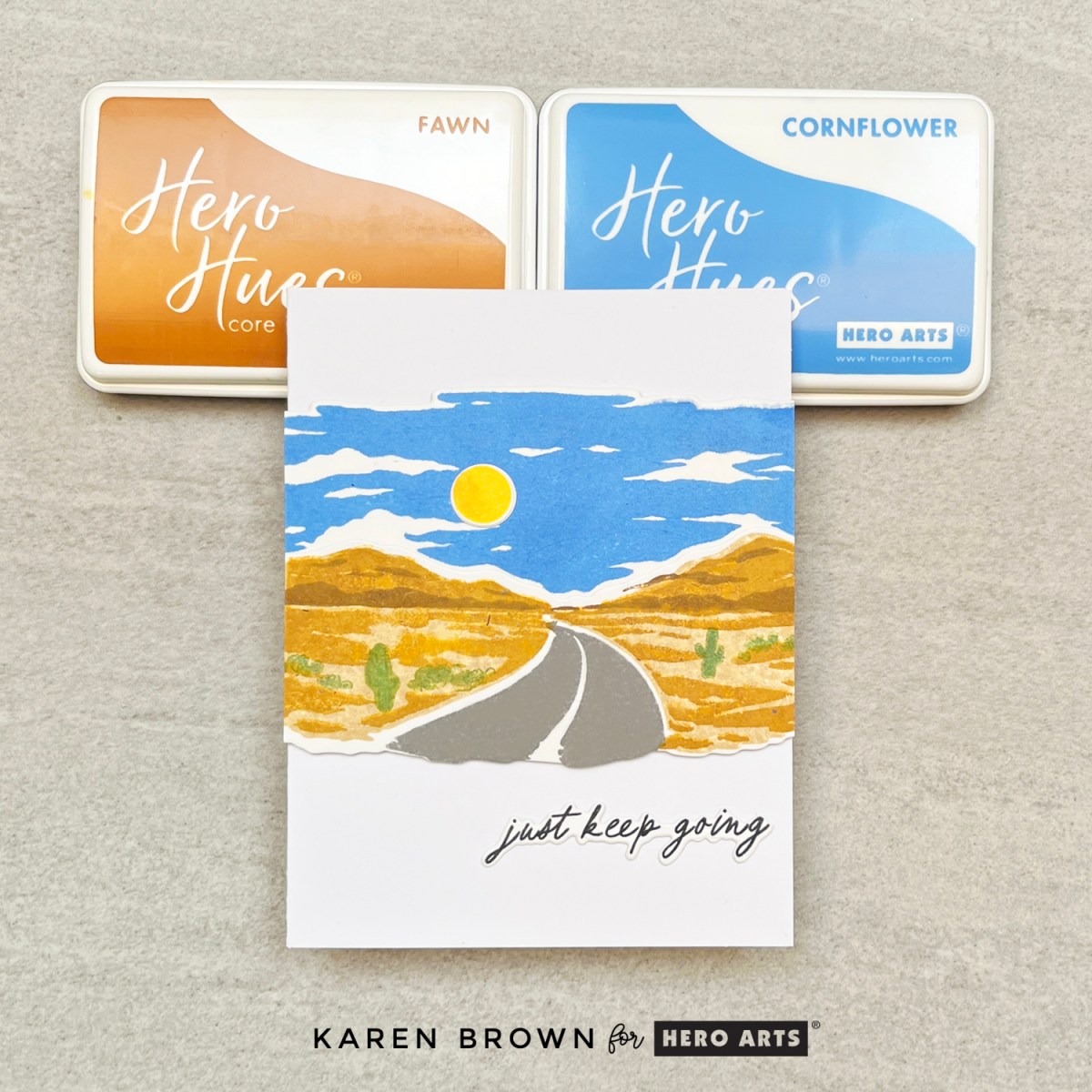 Road trip Heroscape card with a winding desert road, blue sky, and “just keep going” sentiment.