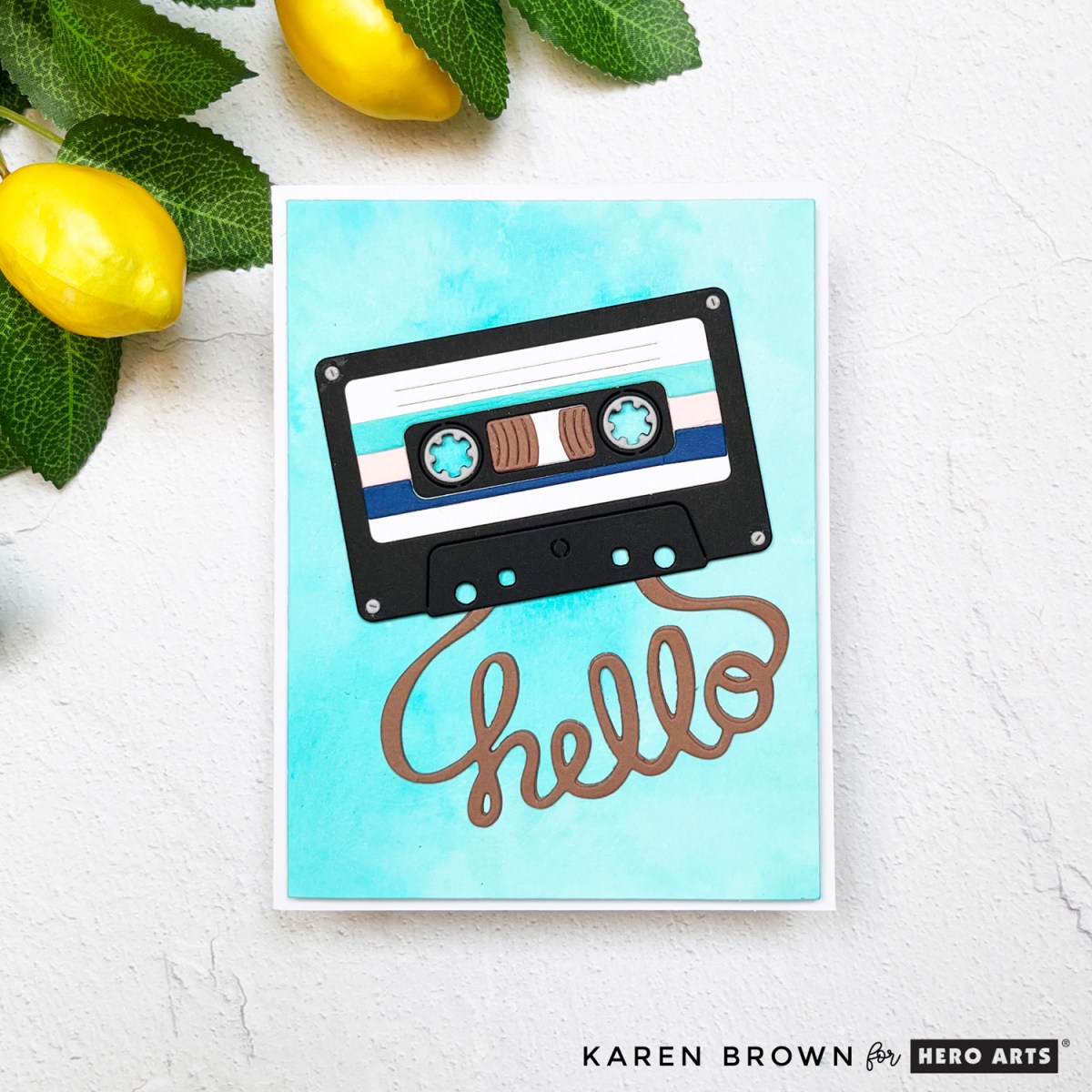 Retro cassette tape card with ink-smooshed blue background and whimsical “hello” shaped like audio tape.