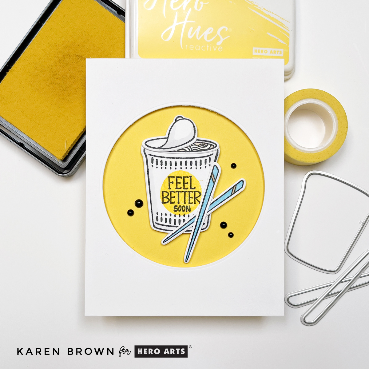 A simple and easy handmade get well card with a die cut yellow recessed circle that showcases and cup of noodle soup, crossed chopsticks and 5 black enamel dots.  