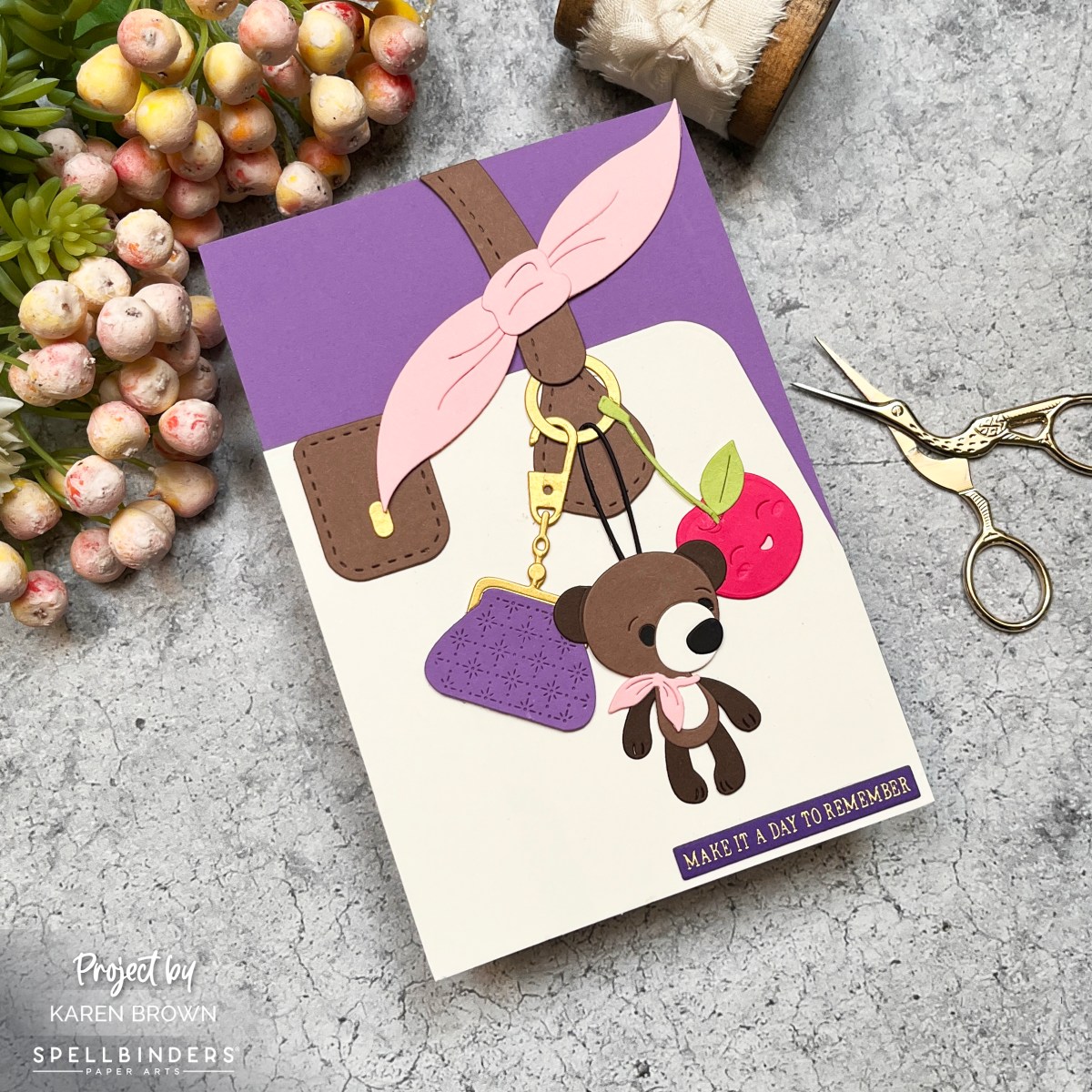 Feminine birthay card featuring a die cut handbag with three cute charms dangling from the handle.