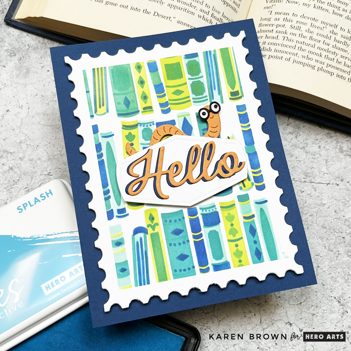 Cute card featuring a stenciled book shelf background and a smiling book worm die cut accent. 