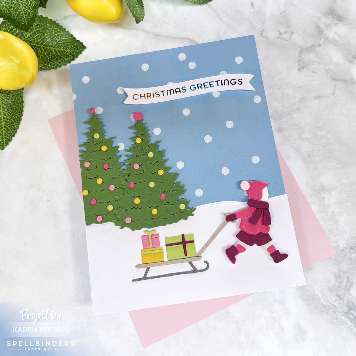 Cute die cut winter scene of a child pulling a sled loaded with gifts through the snow - Christmas Card.