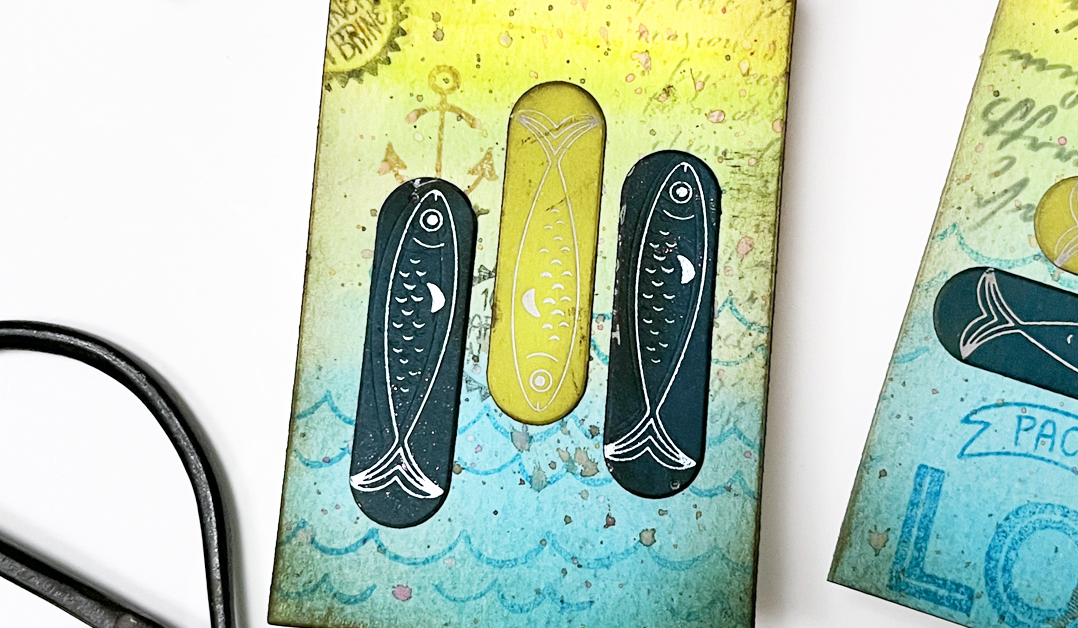 Using distressed Glimmer Hot Foil elements on mixed media tags and cards.