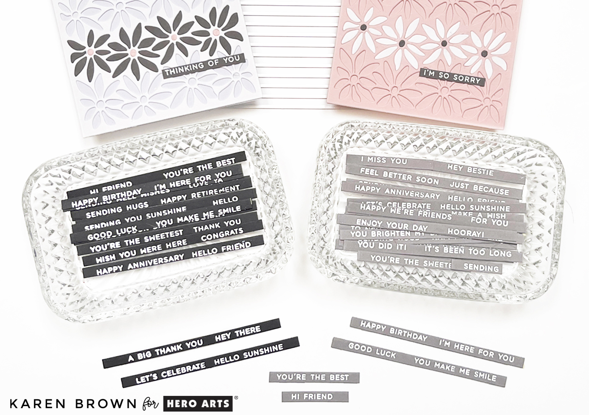 Finished white heat embossed sentiment strips on black and gray cardstock, die cut and ready to use for handmade cards and tags.