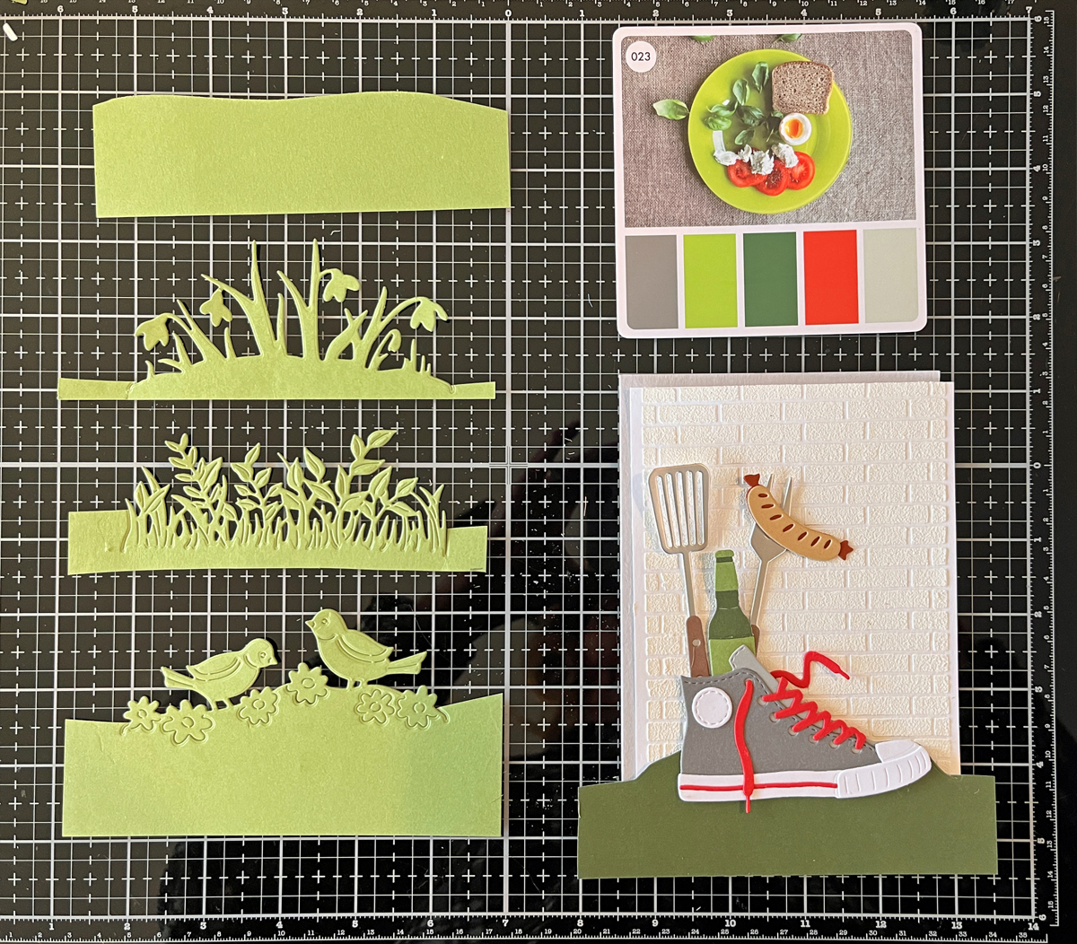 Green die cut foreground options used to ground a die cut scene card....choosing which foreground to use.