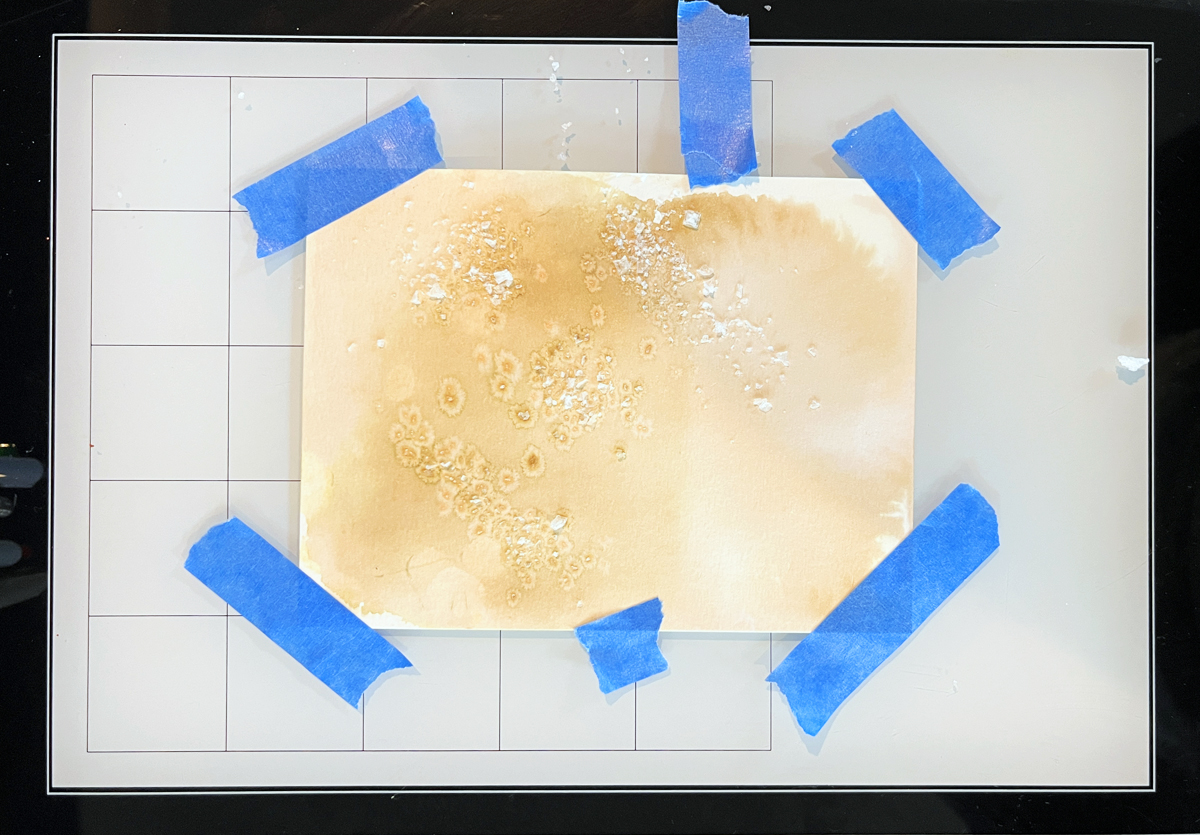 Process photo showing the Ink Smoosh + Salt Technique with tan ink on watercolor paper