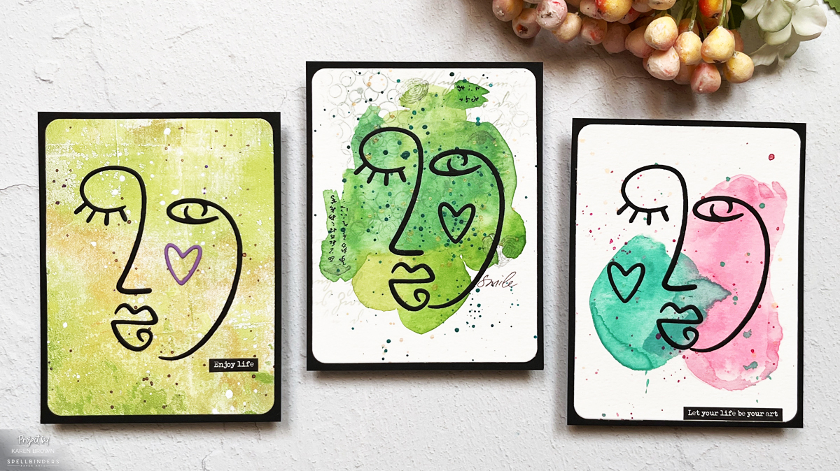 3 modern abstract faces on a handmade card with a watercolor background.