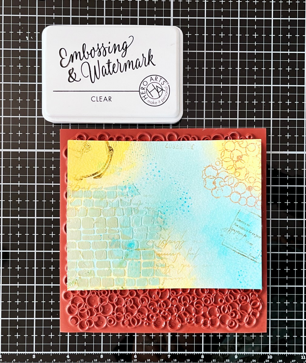 Partial heat embossing bubble circles on a mixed media card background adds texture and interest.