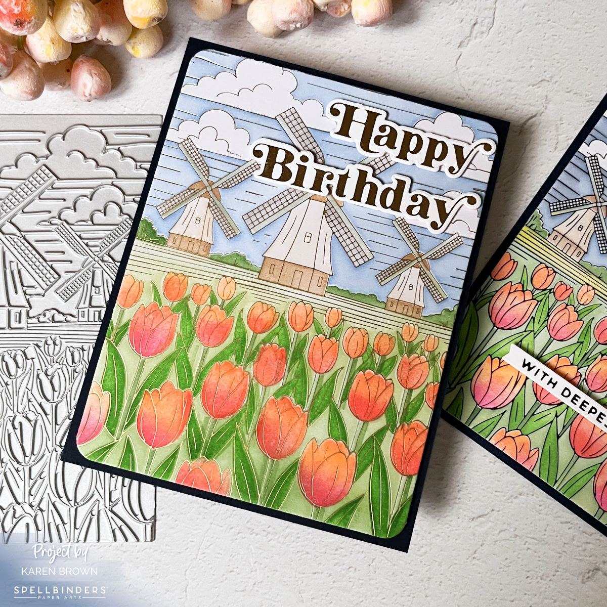 Satin gold foil version of windmill and tulips card with soft blue sky and vivid tulips.