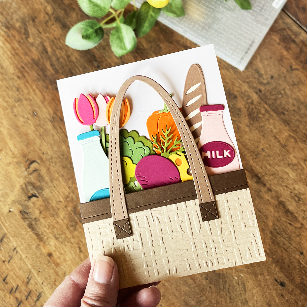 Farmer's market die-cut theme card with tote filled with jugs of milk, baguettes, and veggies.