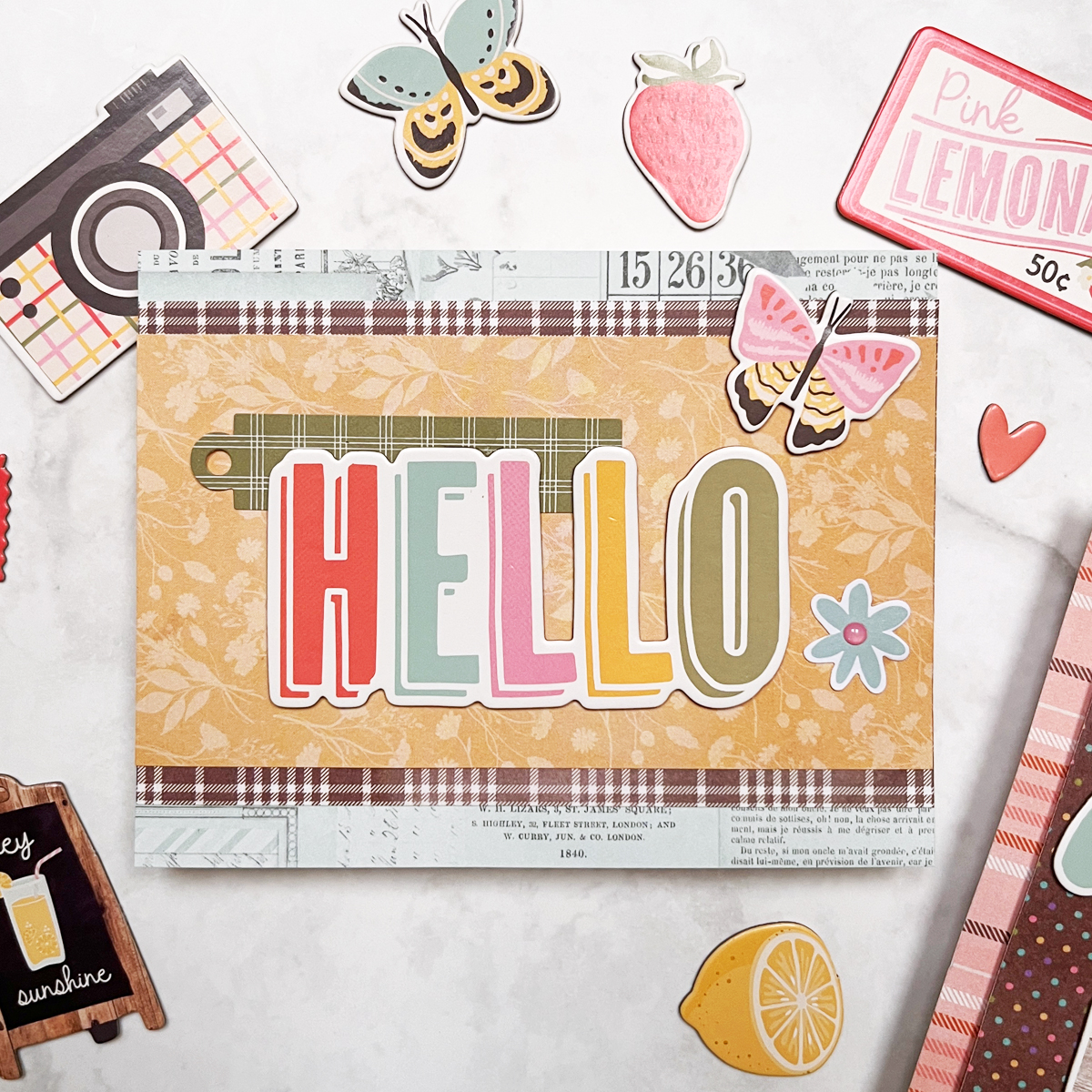 Easy, bright and happy card with layered designer cardstock and chipboard focal points.