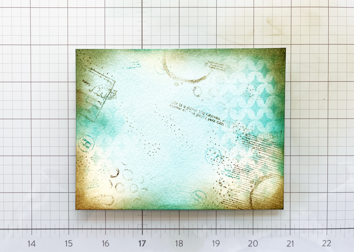 distressing the edges of a background with Root Beer brown ink and a blending brush.