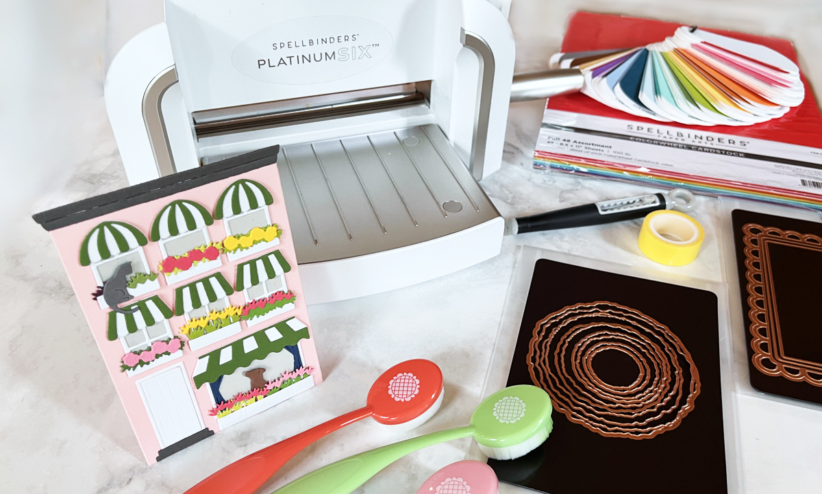 Best die-cutting supplies for cardmaking including Platinum 6 machine, cardstock, infinity dies, frame dies, craft tape, brushes, magnetic storage, and a finished handmade card