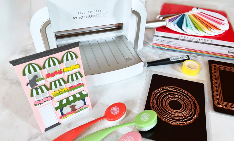 Best die-cutting supplies for cardmaking including Platinum 6 machine, cardstock, infinity dies, frame dies, craft tape, brushes, magnetic storage, and a finished handmade card