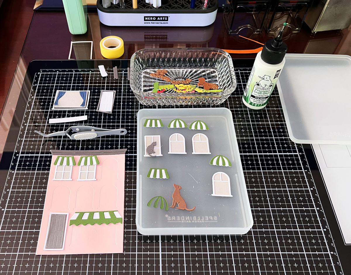 Organized die cut pieces stored in Craft Stax container during cardmaking process