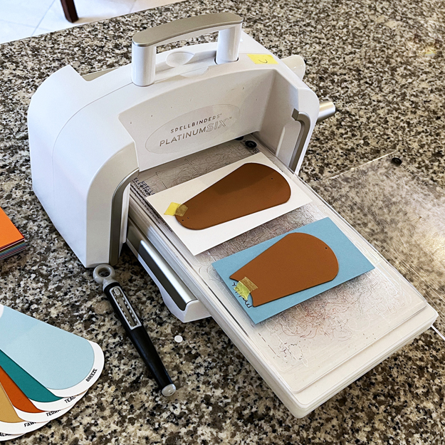 Spellbinders Platinum 6 die cutting machine in action.