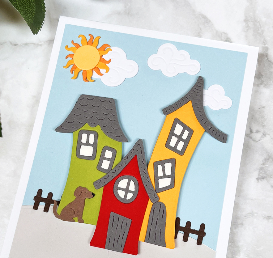 closeup photo of colorful die-cut whimsical house village scene card
