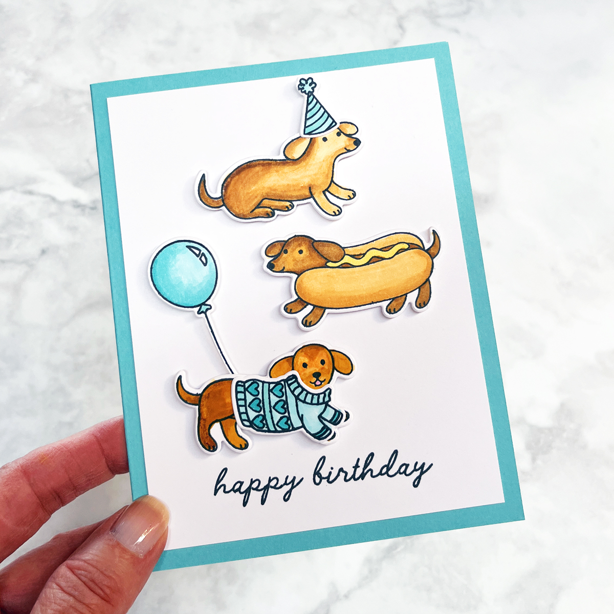 3 adorable "party" dogs stamped and die cut on a funny happy birthday card.