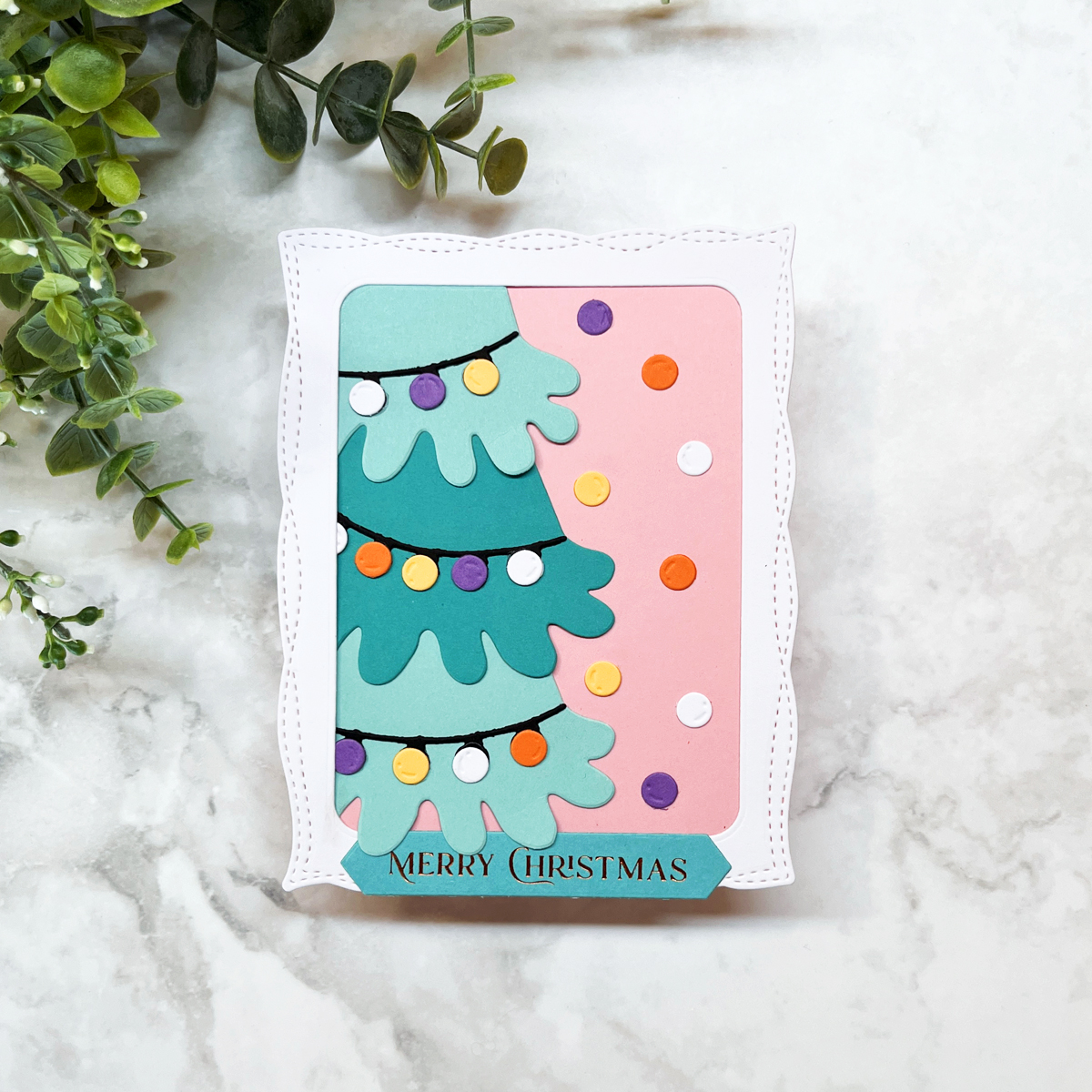 Whimsical die-cut Christmas tree card in teal and pink.
