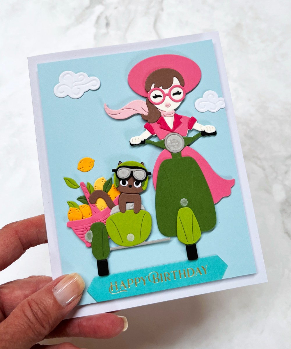 My Monthly Hero July 2026 Summer Scene Card with girl on a scooter with a sidecar.