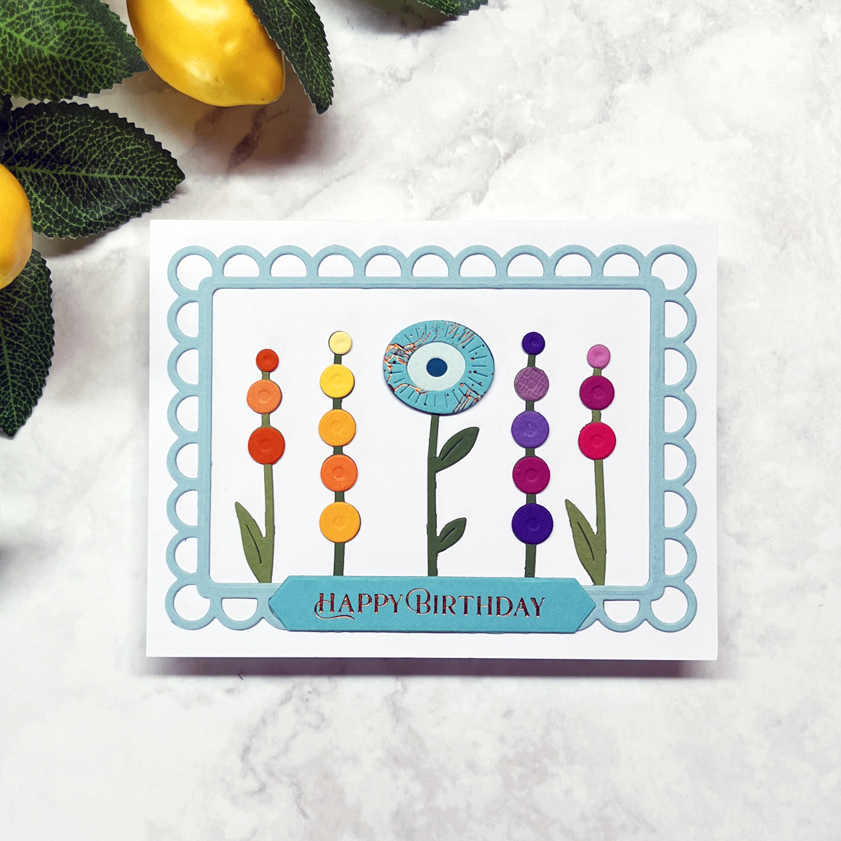 Spellbinder Whimsical Blooms floral birthday card in rainbow colors.