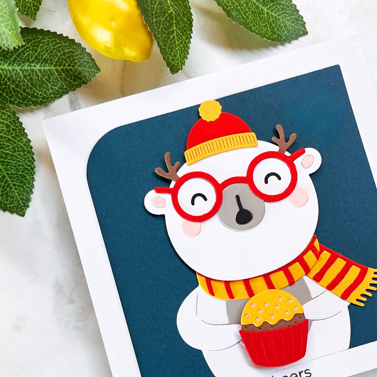Close-up photograph highlighting the spinning cupcake, layered die cuts, and expressive polar bear.