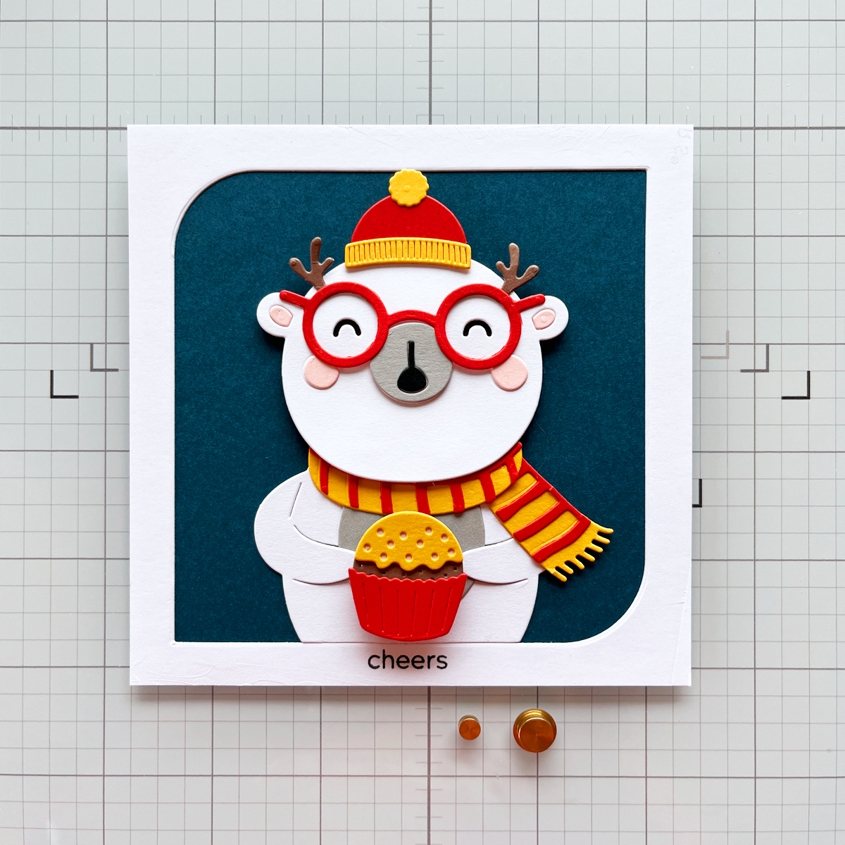 Interactive bear "spinner' card on craftmat with 2 sizes of "spinners" below the card to give readers an idea of spinner product look and size.